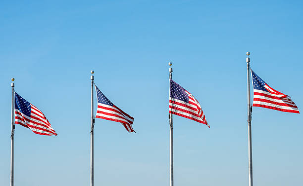 istock Four US flags waving in the wind 2224516616