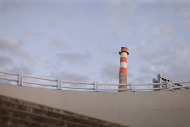 istock An Industrial Chimney and Structure Stand Tall Against a Cloudy Sky Today 2224517326