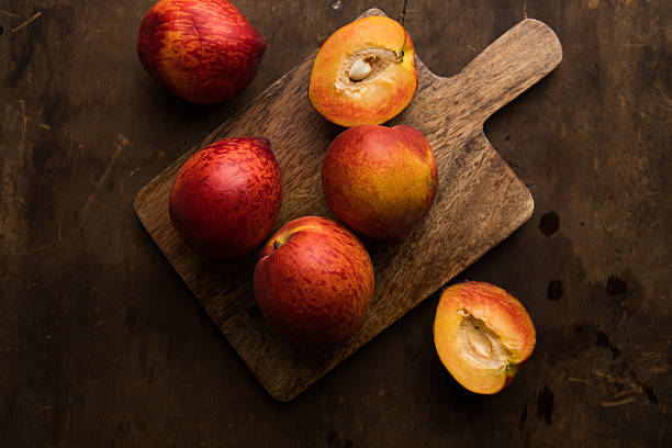 istock Fresh peaches on wooden table 2224520004