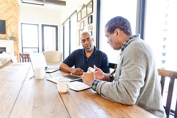 istock Two Mature Men Having a Serious Discussion at a Table 2224520038