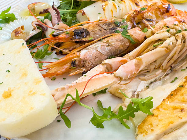 istock Grilled seafood platter with shrimp, squid, and cheese garnished with arugula 2224520493