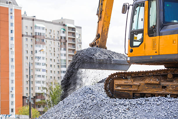 Heavy machinery for construction and landscaping. An excavator on a construction site in close-up. An excavator loads crushed stone into a bucket for construction.