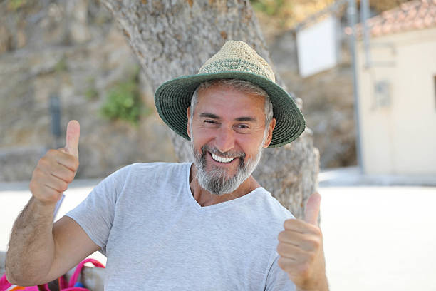 istock Happy Senior Man Relaxing Outdoors in Summer Hat 2224526770