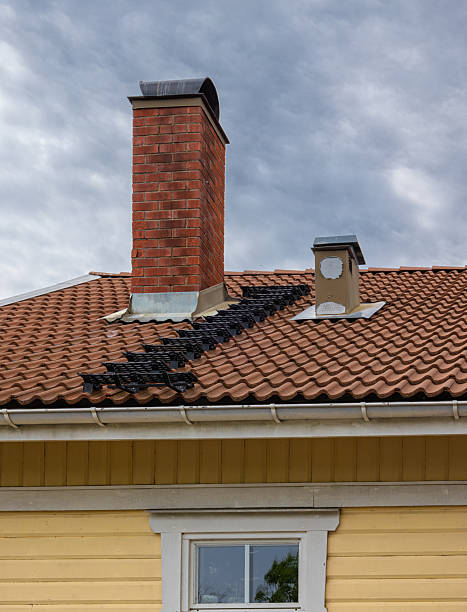 istock Charming Roof with Brick Chimney and Solar Panels 2224527039