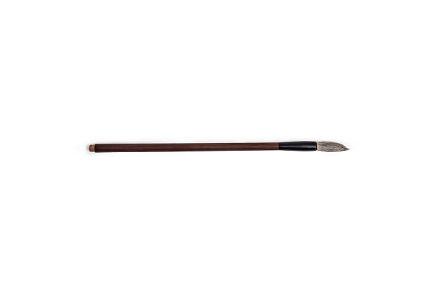 istock A traditional calligraphy brush with a long, dark wooden handle a pointed, soft bristle tip isolated on white background. Perfect for creating elegant brushstrokes in art, lettering, or calligraphy 2224527423