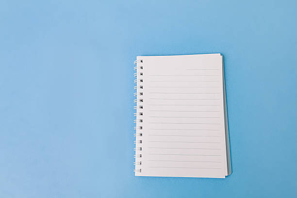 istock An open spiral notebook with lined white pages isolated on light blue background. The clean, minimal design is ideal for use in educational, planning, note-taking, or productivity-related content. 2224527454