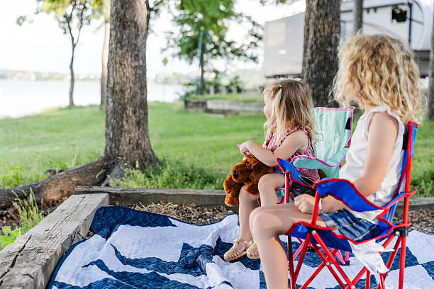 istock Two Girls Sitting Outdoors Enjoying a Summer Day 2224527734