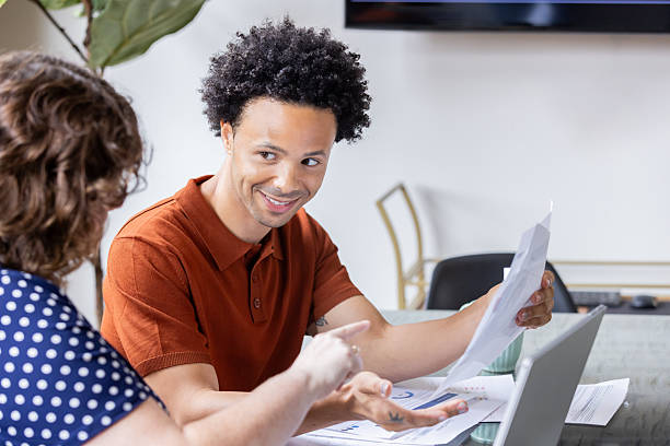 istock Confident young man attends meeting with creative team colleague in modern office 2224528606