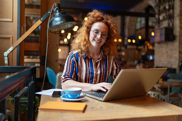 istock Young freelancer working on laptop in cozy cafe 2224530095