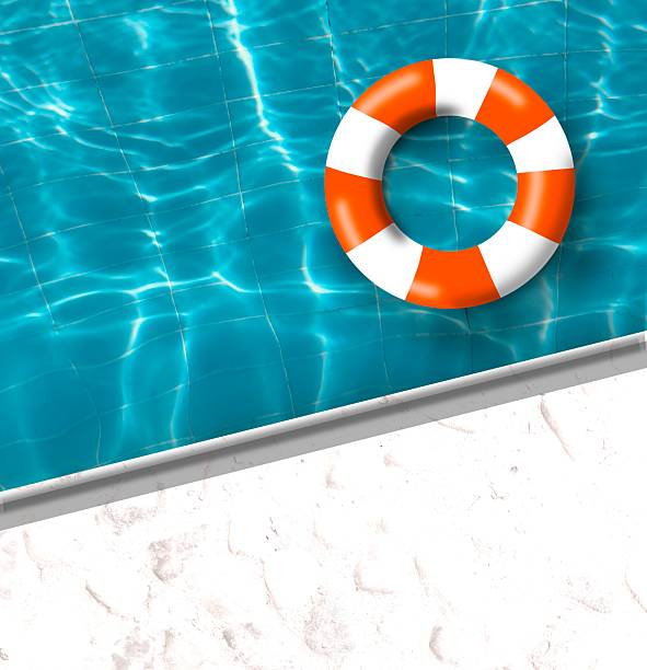 Orange ring floating on vibrant blue swimming pool, orange and white floating buoy on water surface.