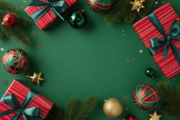 istock Cheerful holiday theme featuring wrapped presents, colorful ornaments, and festive greenery against a green backdrop. A joyful setting for Christmas celebrations, conveying warmth and holiday spirit. 2224532068