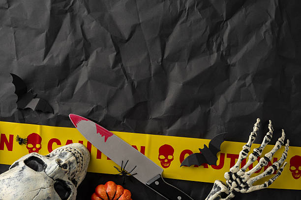 istock Halloween-themed decorative items featuring a skull, skeleton hand, and spooky vibes on a black background 2224532088