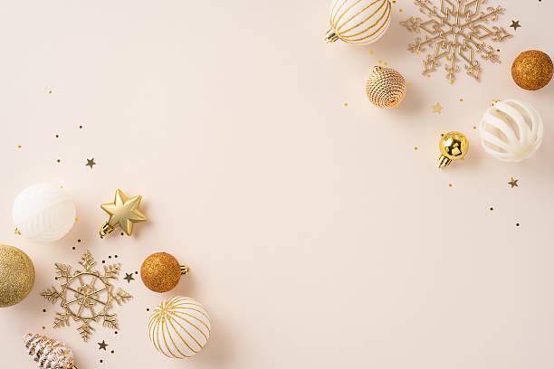 istock Golden decor elements such as baubles, stars, and snowflakes on a soft beige surface decorated with sparkles creating an elegant holiday ambiance 2224532107