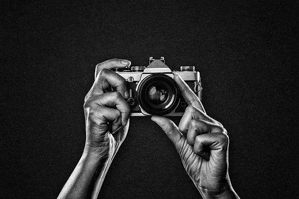 istock Arms up Holding Vintage Camera 2224533927