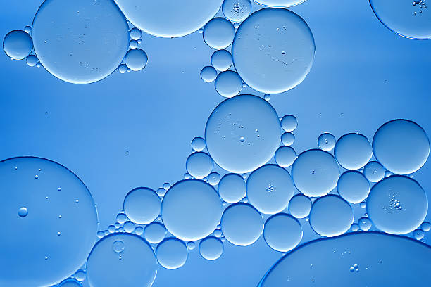 istock Oil bubbles. Oil bubbles on water in light blue tones close-up. Abstract texture 2224534124