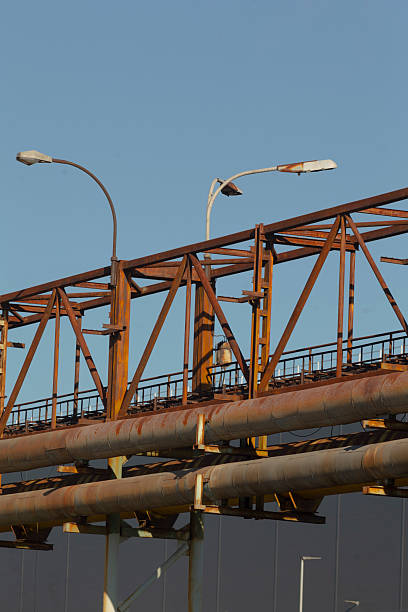 There is a bridge that has a significant number of pipes running over it, creating an intricate and complex design for the structure