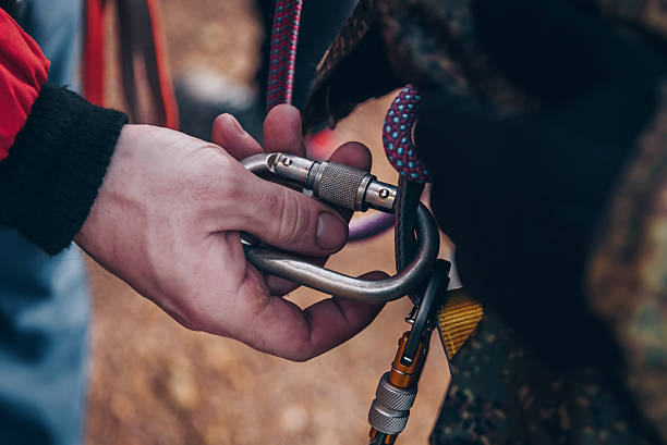 istock Rock climber tying knot on rope for climber, man preparing climbing equipment 2224536548