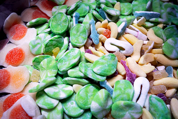 Close up photo of green jelly bean mint candies sprinkled with sugar.