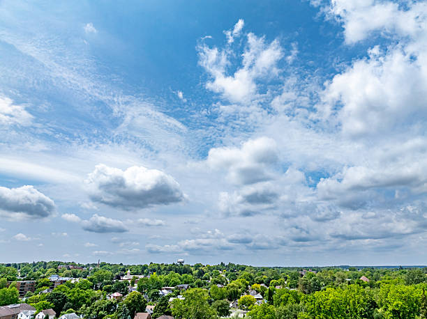 istock Blue sky, white clouds and residential area in the trees 2224548719