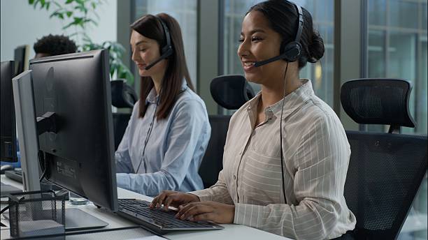 istock Happy multiethnic business agents operators working call center computer helpline diverse Indian Caucasian businesswomen African businessman headset speak phone online consultation callcenter office 2224551862