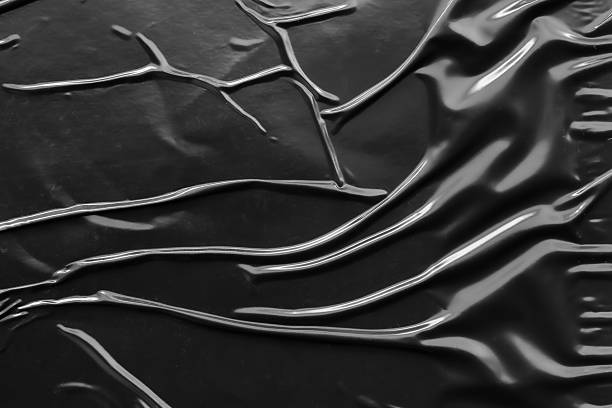 istock black crumpled and creased plastic poster texture background 2224552834