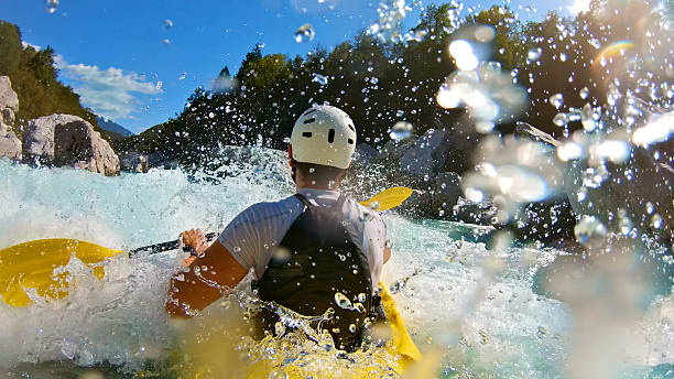 istock A kayaker in a yellow kayak navigates through a white-water river 2224552927