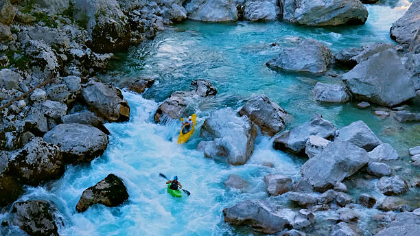 istock Kayakers navigate rapids, conquering the wild river's mighty waves 2224552951