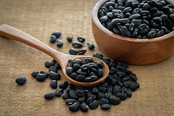 istock Black bean on wooden spoon 2224553929