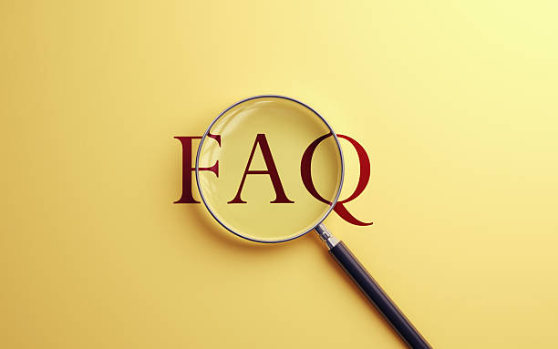 istock FAQ Text Selected with Metallic Magnifying Glass on Soft Blue Background 2224555884