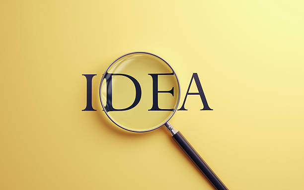 istock İdea Text Selected with Metallic Magnifying Glass on Soft Blue Background 2224555887