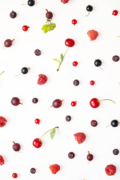 istock Various fresh ripe berries including cherries, raspberries and gooseberries scattered on a white background. 2224555905