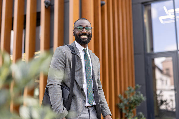 istock Professional man smiling while standing near modern building 2224557203