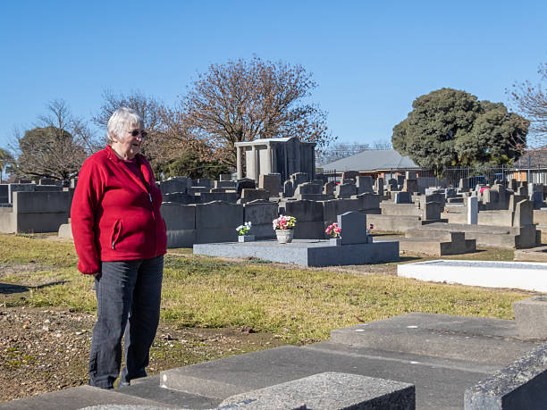 istock Senior woman visiting a cemetery 2224558812