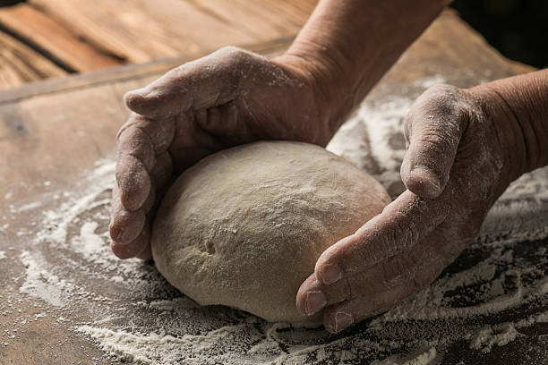 istock Elderly Hands Kneading Dough for Homemade Bread 2224561821