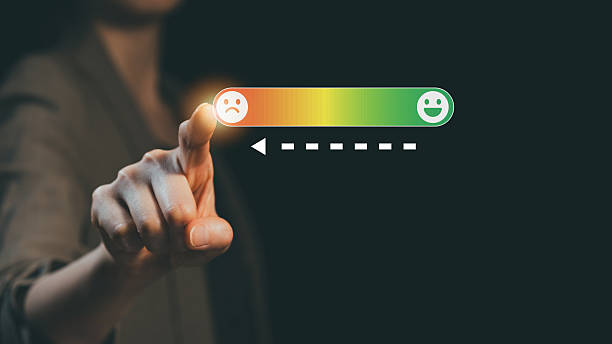 istock Hand pointing to sad face on customer satisfaction scale showing low feedback rating concept of brand loyalty quality service measurement 2224563908