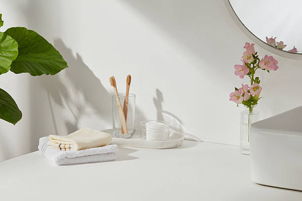 istock Bathroom with bamboo toothbrushes, white sink, and blooming pink flowers. Soft shadows and daylight enhance the peaceful vegan aesthetic. 2224567268