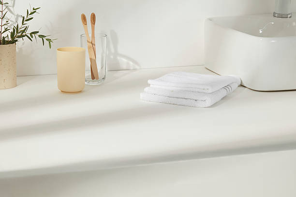 istock Bathroom sink with bamboo toothbrushes, soap bottle, folded towels, and green branches. Bright and fresh, reflecting a clean and conscious lifestyle. 2224567281