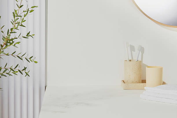 istock Toothbrushes and soap bottle in eco-friendly holders on marble surface. Clean lines and fresh greenery in a modern minimalist bathroom setup. 2224567284