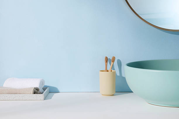 istock Bright bathroom with light blue wall, green sink, and bamboo toothbrushes. Soft sunlight and pastel palette reflect a young, feminine self-care ritual. 2224567288
