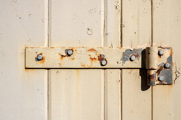 istock Rusty door hinge on an old wooden door 2224567493