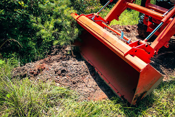 istock close-up of a front loader on tractor in a wooded area construction design element 2224570141