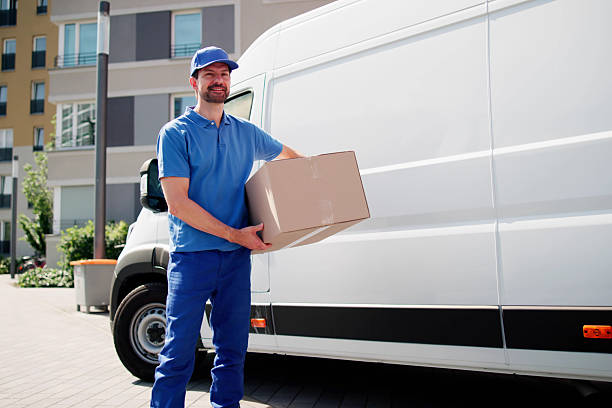 istock Professional Delivery Man Moving Boxes And Delivering Goods To Customers 2224573358
