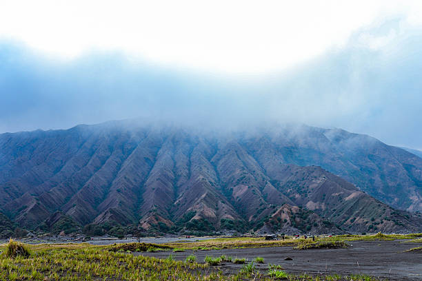 Early morning at Mt Bromo, Java Island, Indonesia. Many people make their way up to the edge of the caldra of this active volcano. Locals are present with horses offering rides and 4wd off-road for tourist