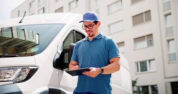 istock Happy Hispanic Courier Using Tablet To Deliver Packages 2224573410
