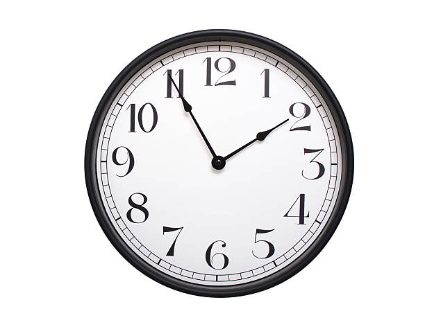 Round analog wall clock with a black frame, white face, and bold black numerals. showing  01:55 or 13:55. Isolated on a white background. Ideal for time-related themes.