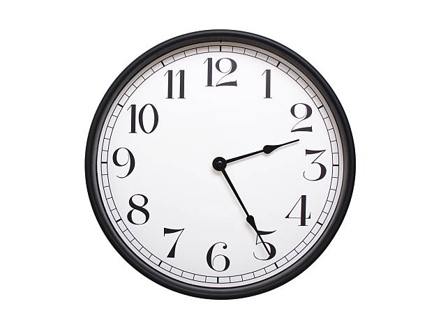 istock Round analog wall clock with a black frame, white face, and bold black numerals. showing  02:25 or 14:25. Isolated on a white background. Ideal for time-related themes. 2224577177