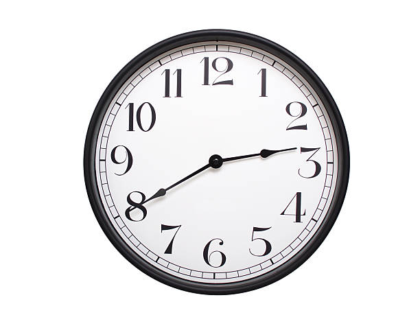 Round analog wall clock with a black frame, white face, and bold black numerals. showing  02:40 or 14:40. Isolated on a white background. Ideal for time-related themes.