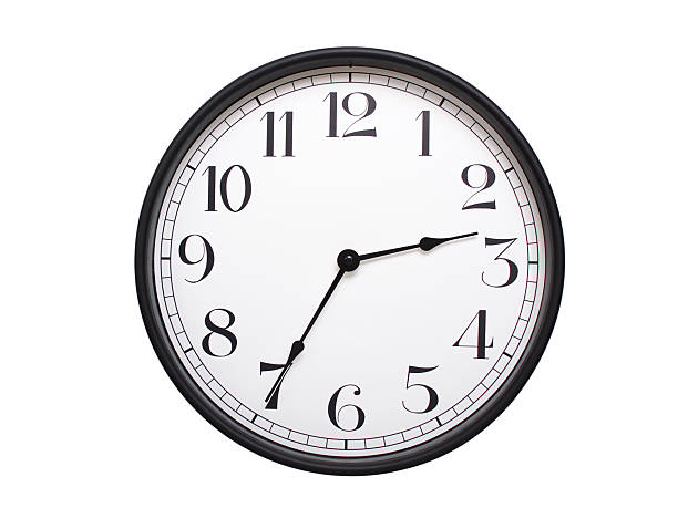 Round analog wall clock with a black frame, white face, and bold black numerals. showing  02:35 or 14:35. Isolated on a white background. Ideal for time-related themes.