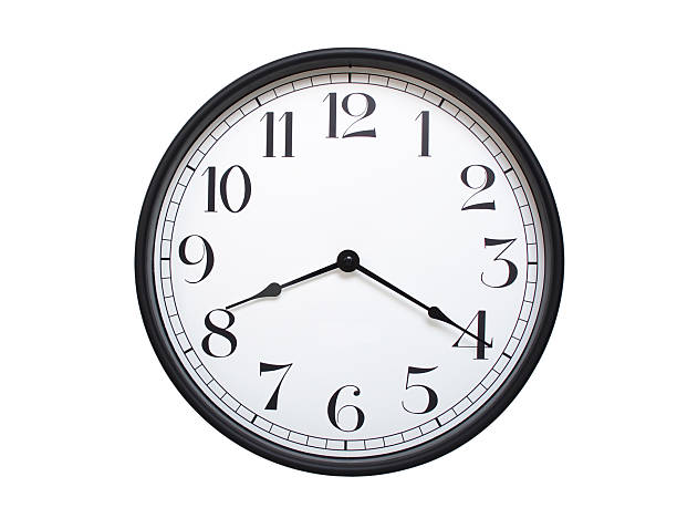 istock Round analog wall clock with a black frame, white face, and bold black numerals. showing  08:20 or 20:20. Isolated on a white background. Ideal for time-related themes. 2224577372