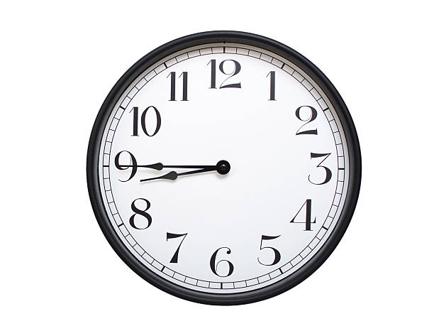 istock Round analog wall clock with a black frame, white face, and bold black numerals. showing  08:45 or 20:45. Isolated on a white background. Ideal for time-related themes. 2224577375